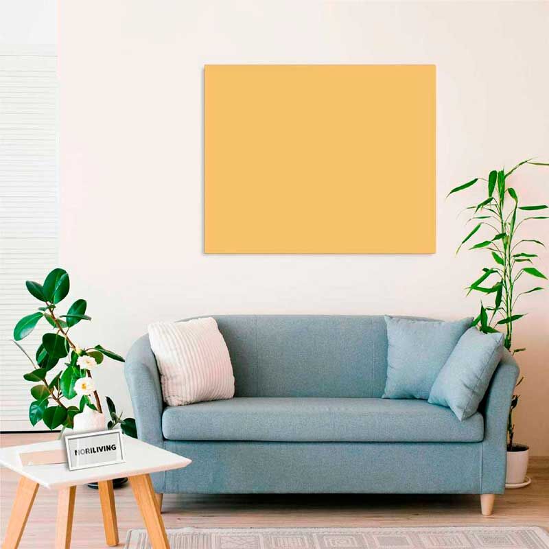Ein modernes Wohnzimmer mit einem blauen Sofa, einem weißen Kissen, einem Beistelltisch mit einer Pflanze und einem gelben Wandbild im Hintergrund.