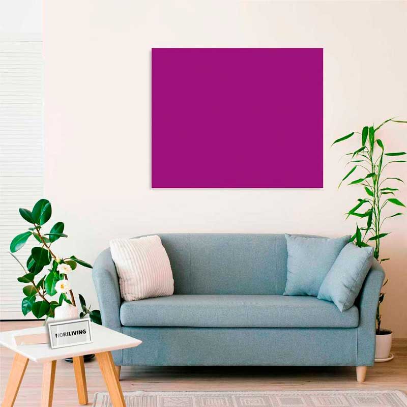 Gemütliches Wohnzimmer mit blauem Sofa, Zierkissen, lila Wandbild und Zimmerpflanzen