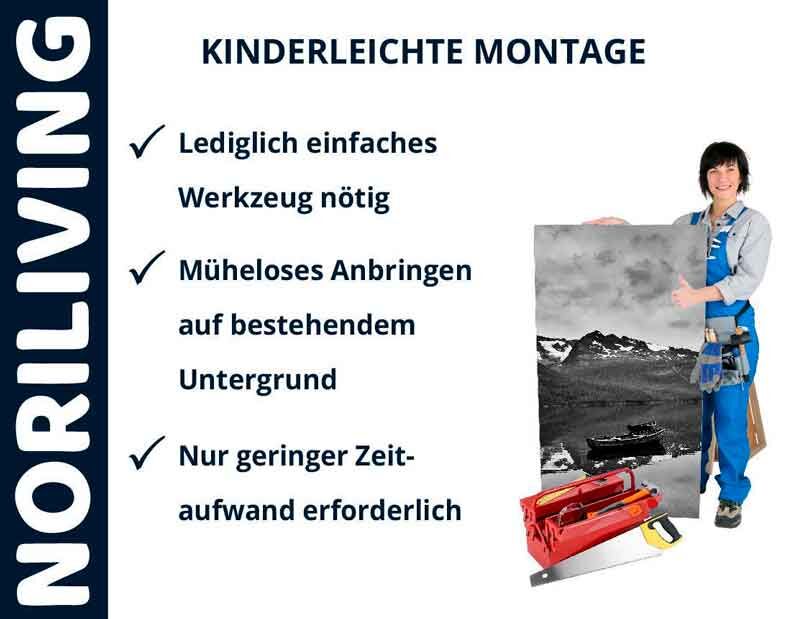 Person in Arbeitskleidung mit Fotoposter vor weißem Hintergrund und Montagewerkzeug, Noriliving kinderleichte Montage mit einfachem Werkzeug und minimalem Zeitaufwand hervorgehoben.