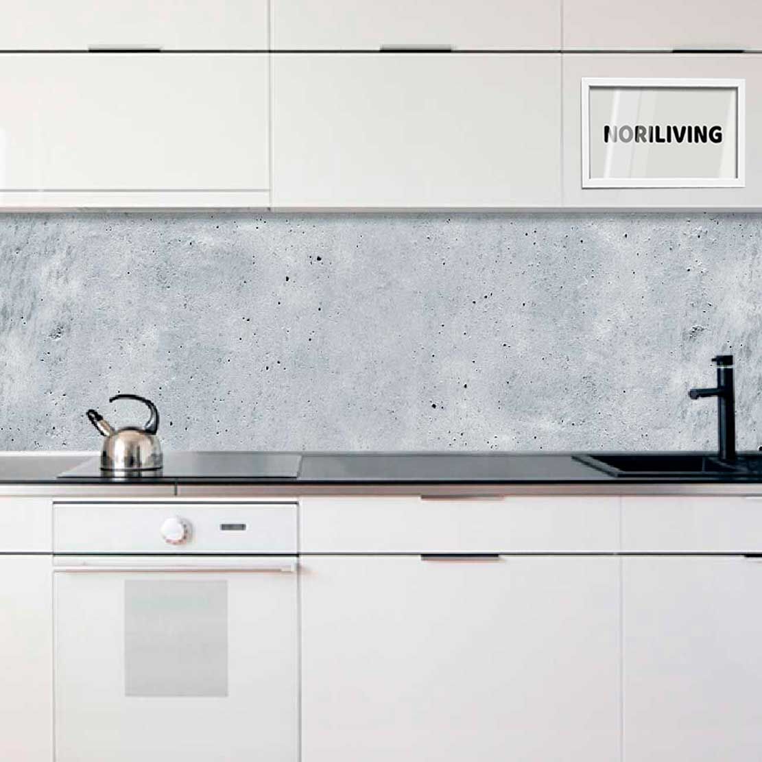 Eine elegante Küche mit weißen Schränken, grauer Betonoptik Rückwand und modernen Armaturen