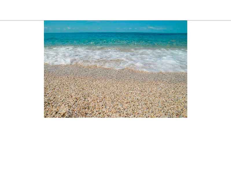Sonniger Strand mit sanften Wellen und türkisfarbenem Wasser