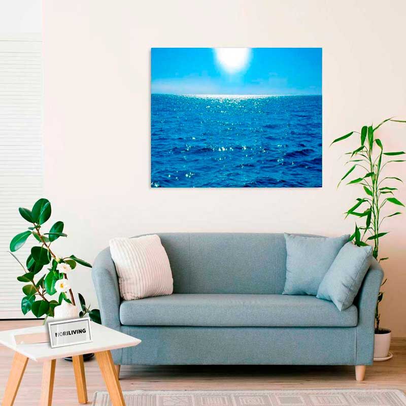 Wohnzimmer mit blauem Sofa, Ozean-Tapete an der Wand und Pflanzen neben dem Sofa