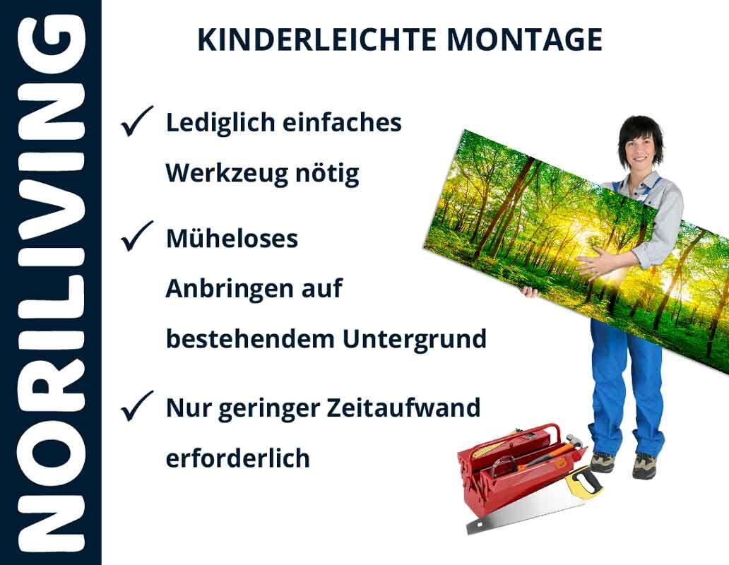 Frau hält ein großes Wandbild mit der Aufschrift 'Kinderleichte Montage'. Werkzeug liegt auf dem Boden. Text beschreibt die einfache Montage mit wenig Aufwand.